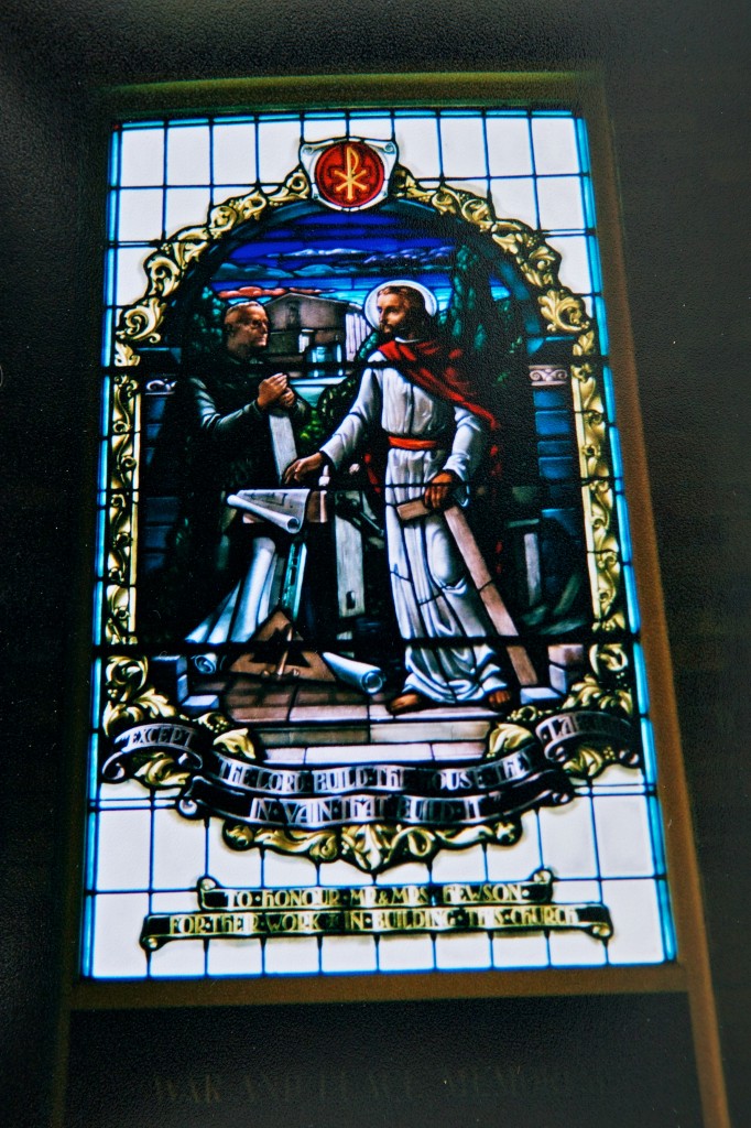 Northbridge Uniting Church Window Photo of a stained glass window showing two men, one kneeling, one standing, and a table between them with what looks like building plans.